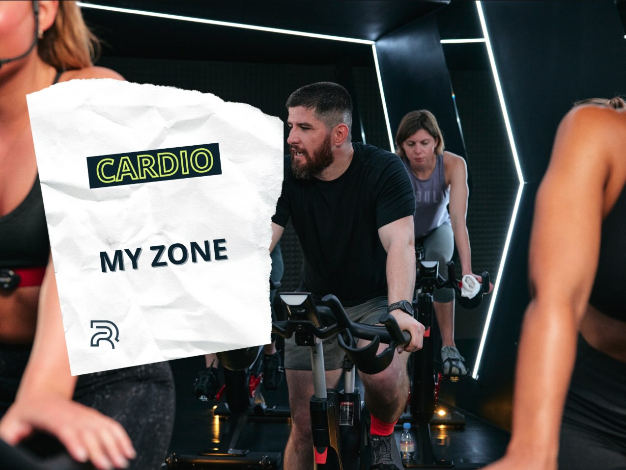 séance de biking intense dans une salle de sport design, pratiquants concentrés sur leur performance cardio avec suivi de zones d’effort MyZone
